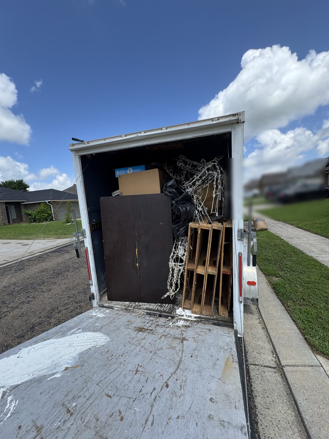 Aggie Haulers trailer loaded with junk and furniture headed for disposal